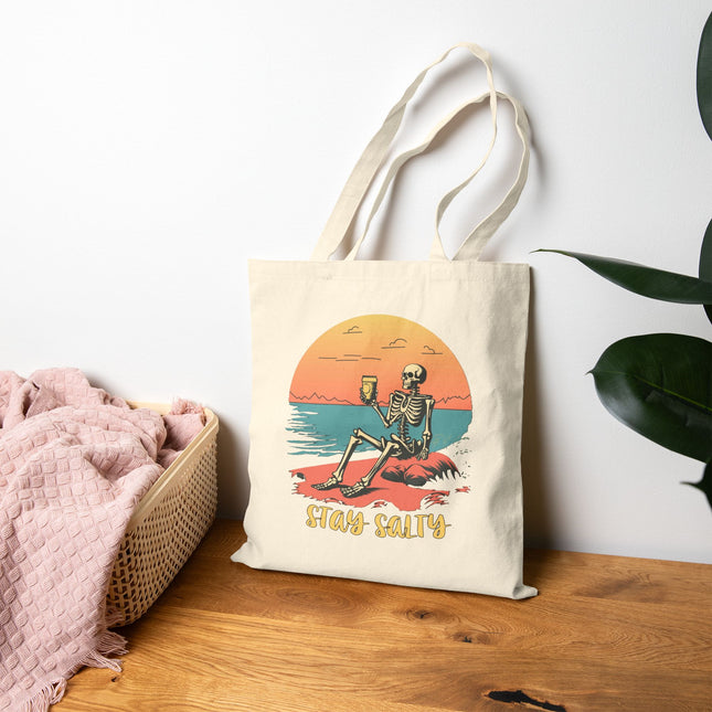 Stay Salty Canvas Tote Bag, Skeleton Relaxing on the Beach, Perfect for shopping & gifting. Sunset, funky, playful, sassy, shoulder bag.
